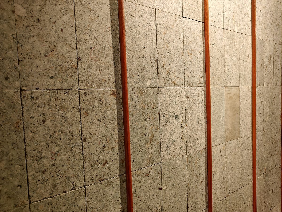 Sukabhumi Stone wall with copper accents at KAYU